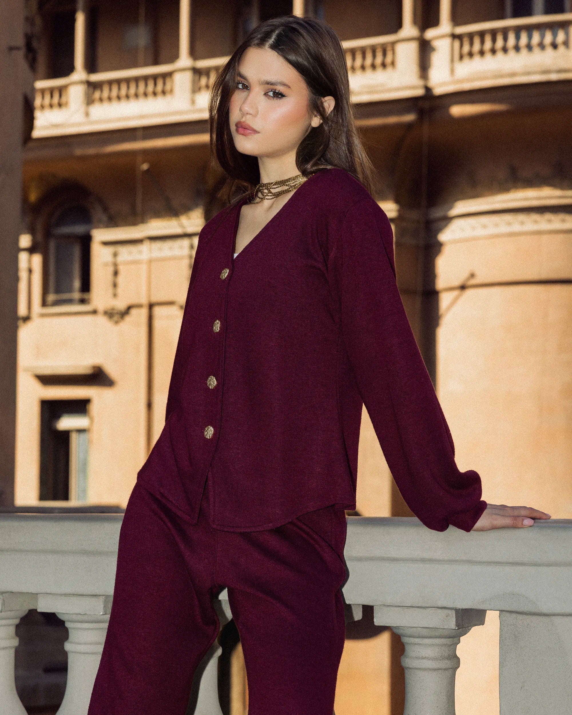 “Model wearing the burgundy Lounge Set in a front-standing balcony pose showing the warm knit texture and relaxed silhouette.”