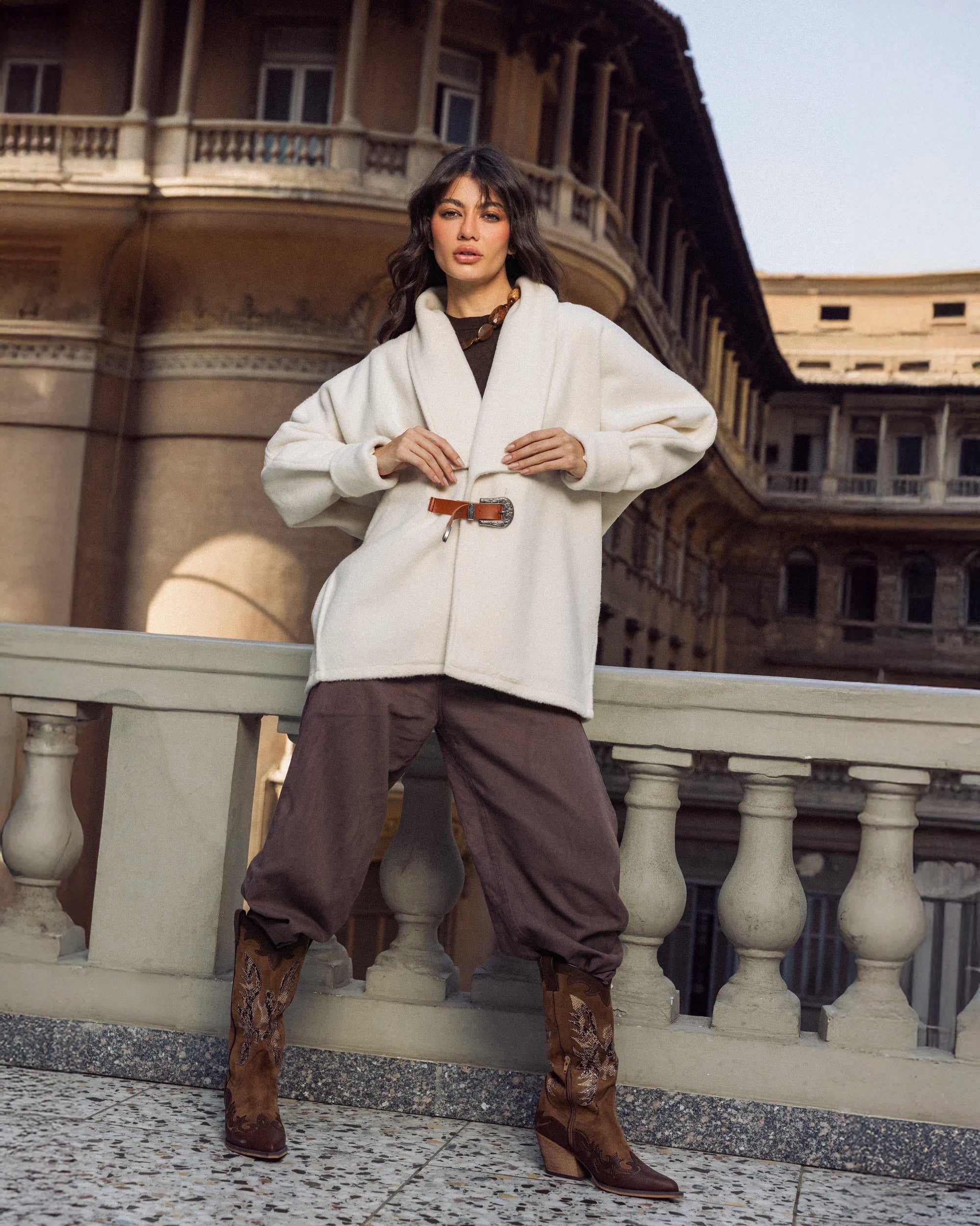 “Full-body view of the white Belted Jacket highlighting the oversized wool silhouette and slim belt.”
