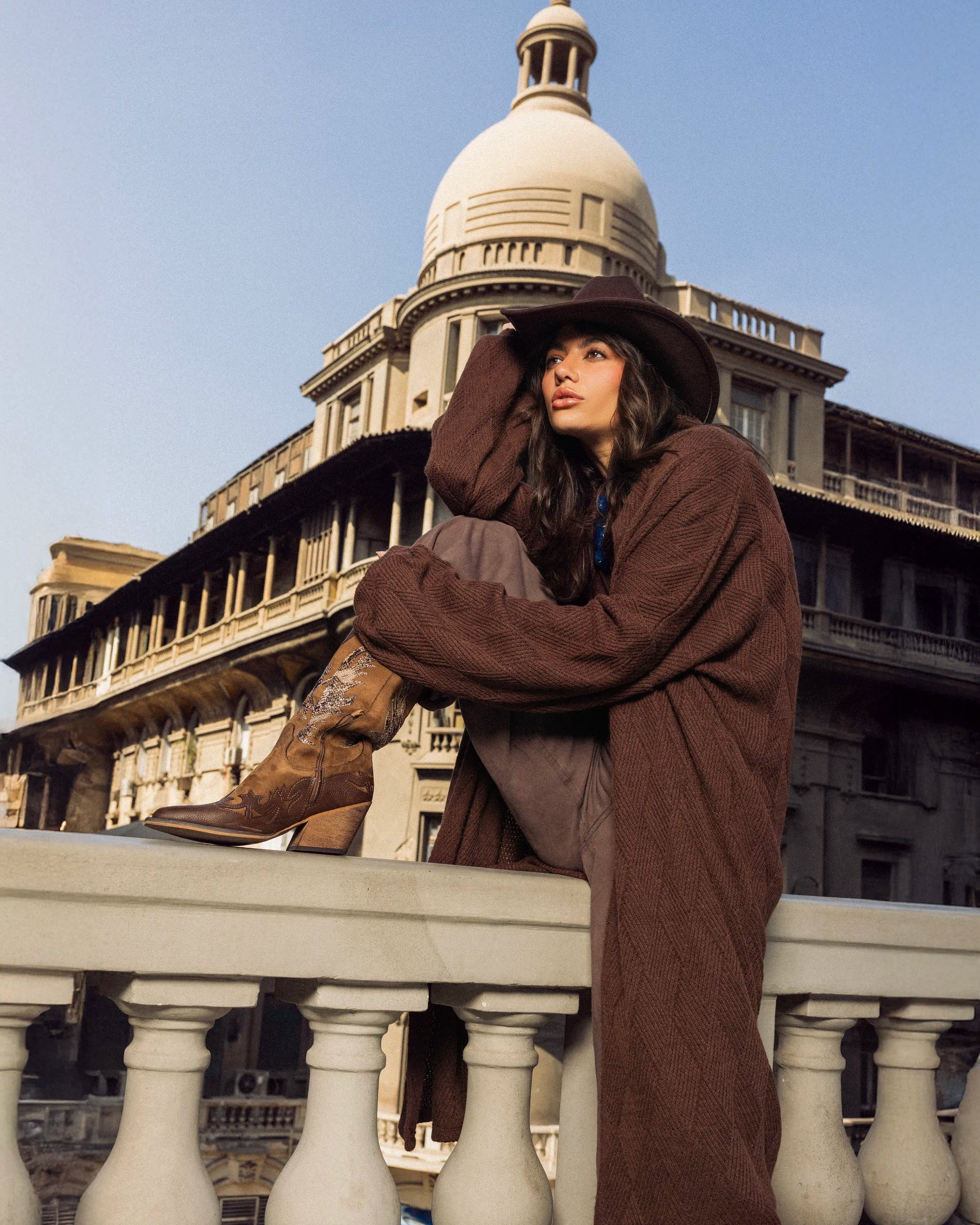 “Close-up upper-body view of the brown Wander Coat showing the soft-knit texture and relaxed drape.”