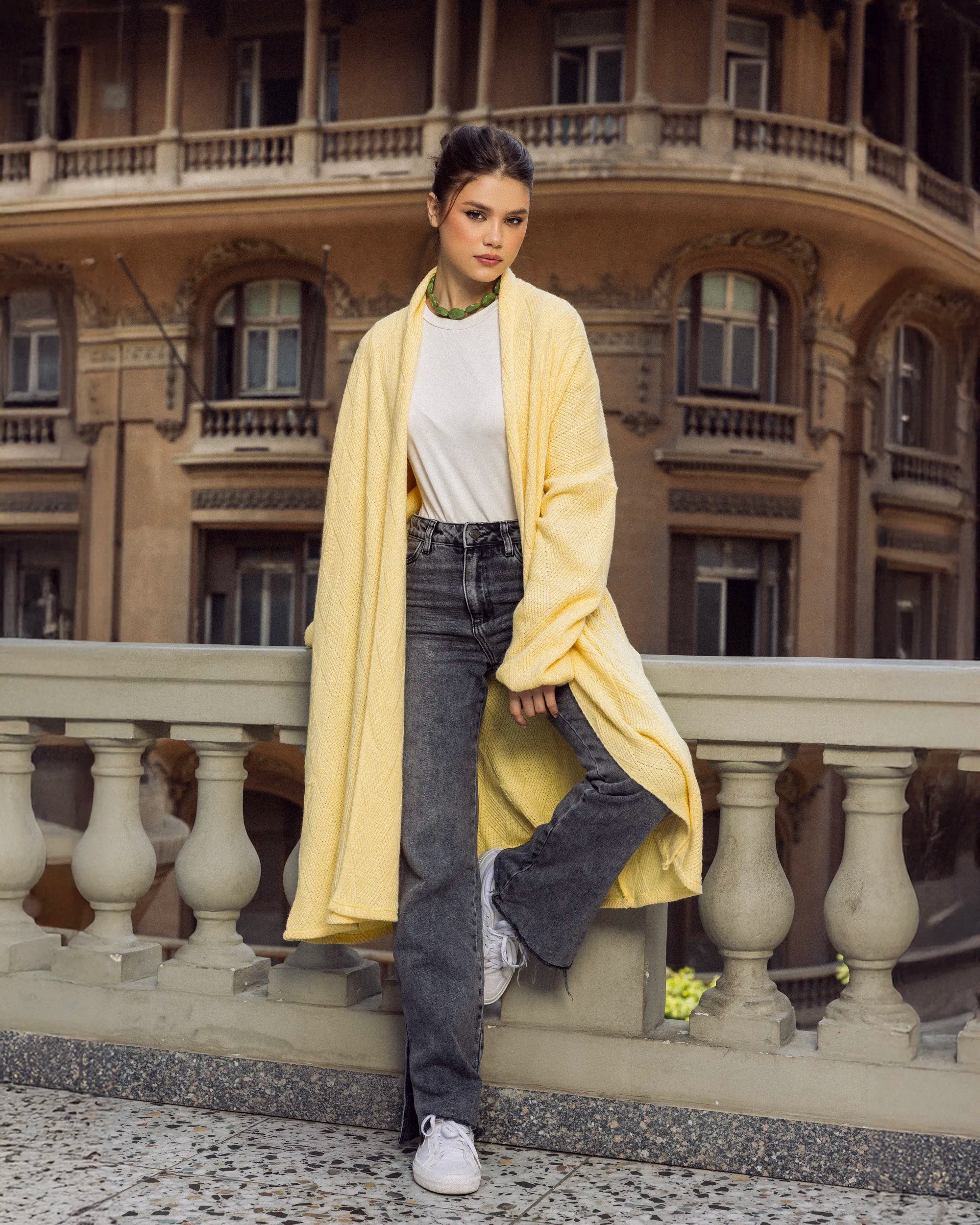 “Full-body view of the yellow Wander Coat highlighting its long soft-knit design and warm winter fit.”
