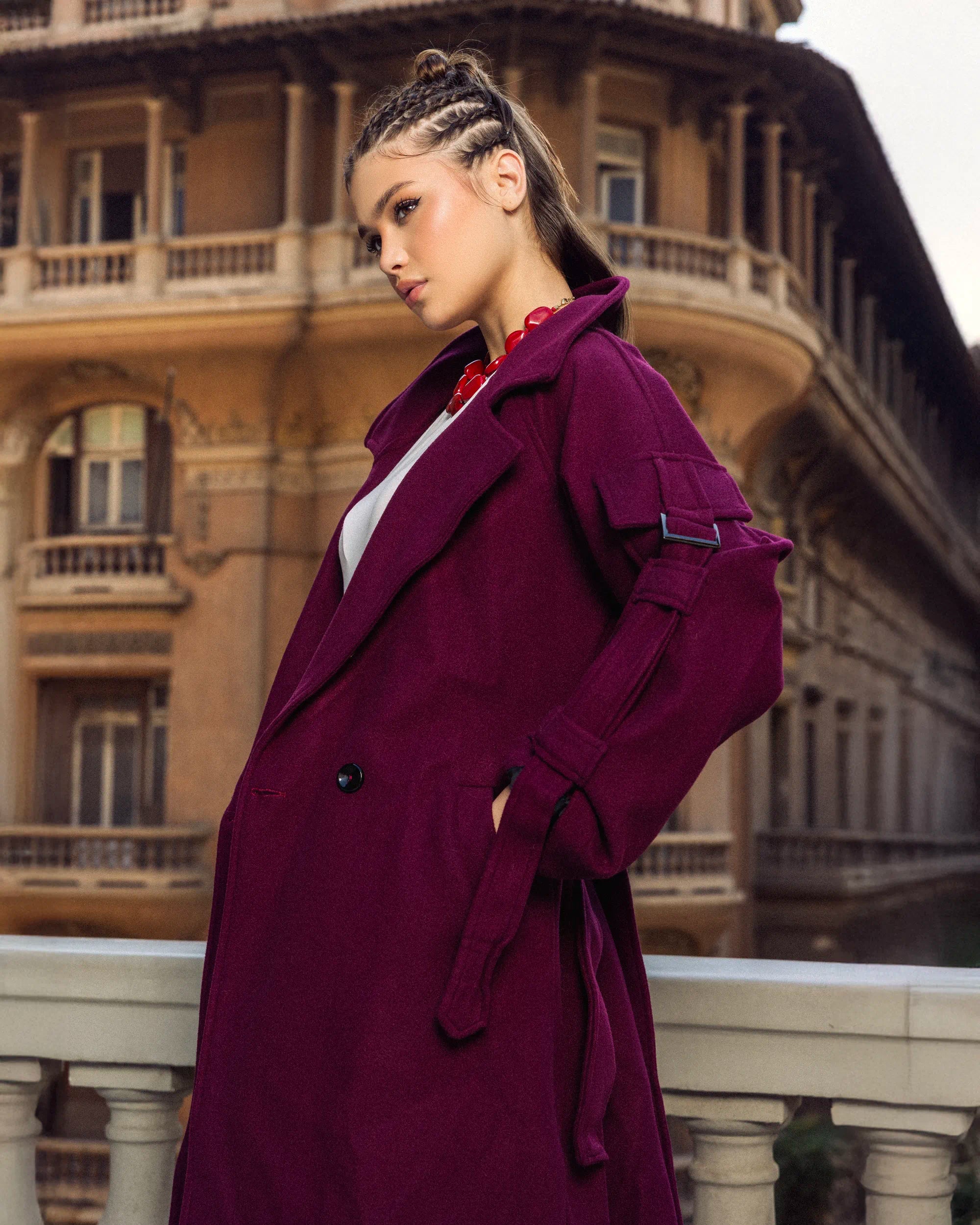 “Walking pose view of the beige Bound Coat showing its relaxed tailored silhouette and subtle belt.”
