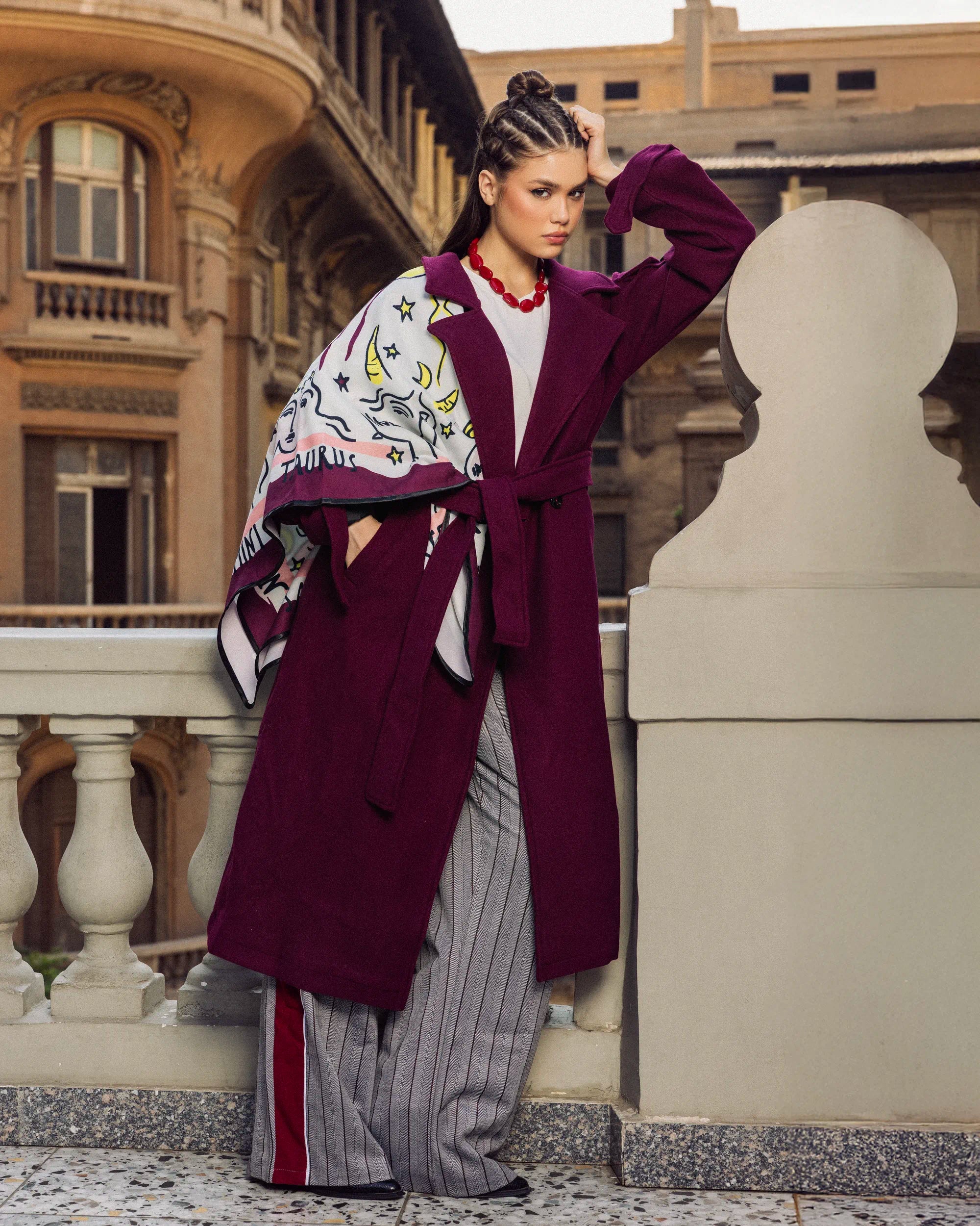 “Walking pose of the burgundy Bound Coat emphasizing its wool structure and elegant movement.”