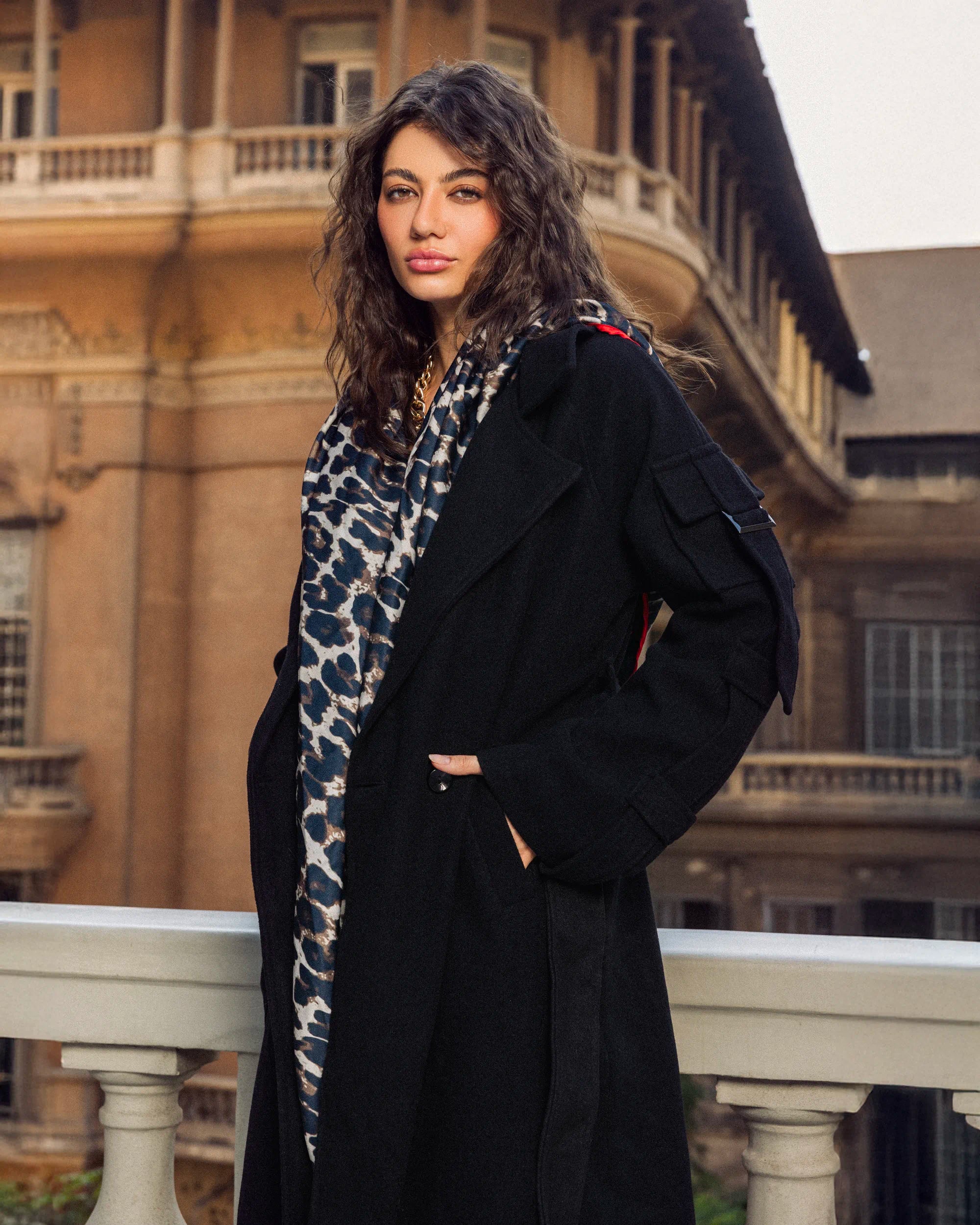 “Close-up side profile of the black Bound Coat showing the wool texture and structured silhouette.”