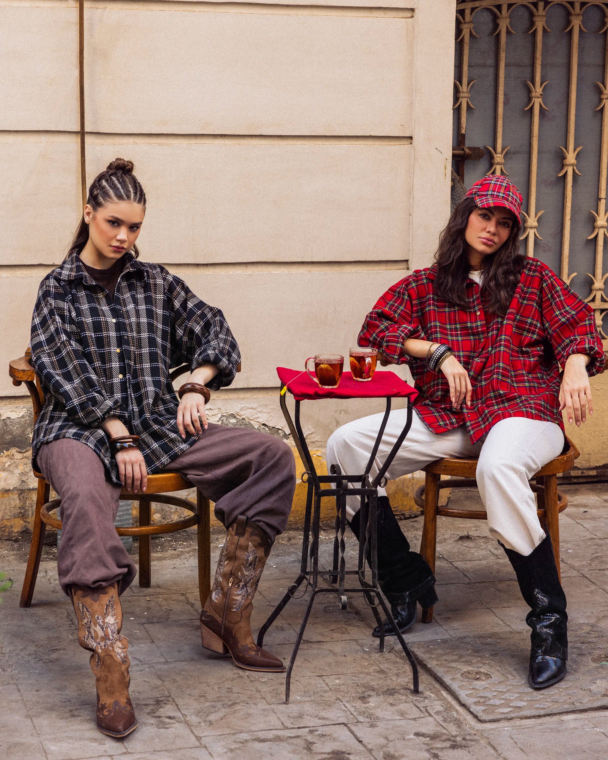 “Two models wearing the Griddy Shirt in red and dark plaid, showcasing the oversized wool fit for winter layering.”