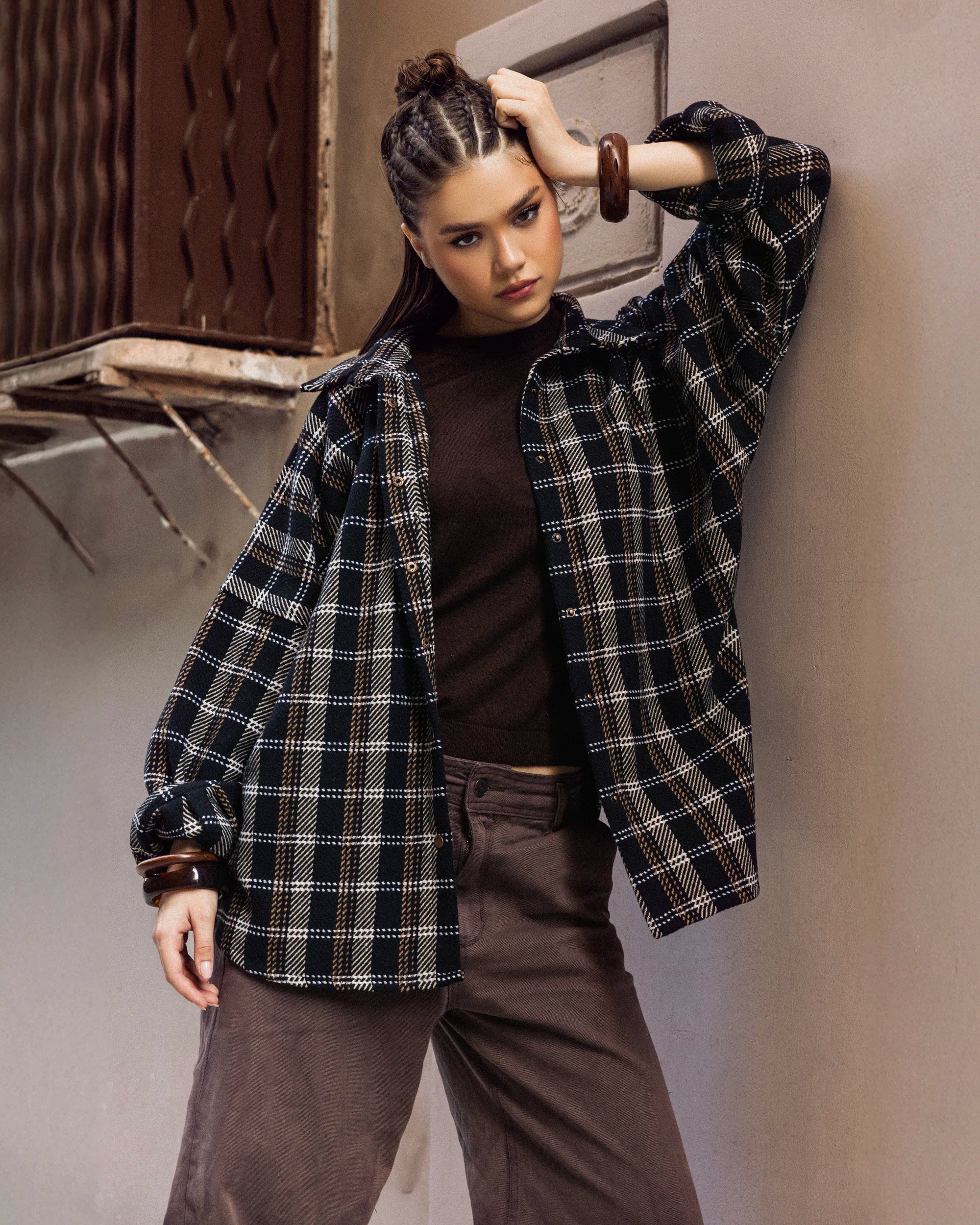 “Front view of the dark wool plaid Griddy Shirt styled with a laid-back winter look.”