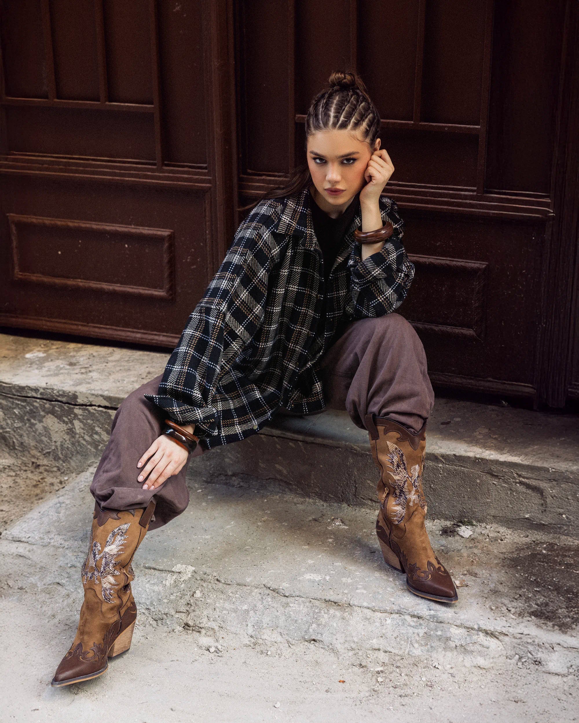 “Walking pose showing the oversized dark plaid Griddy Shirt and its relaxed winter fit.”