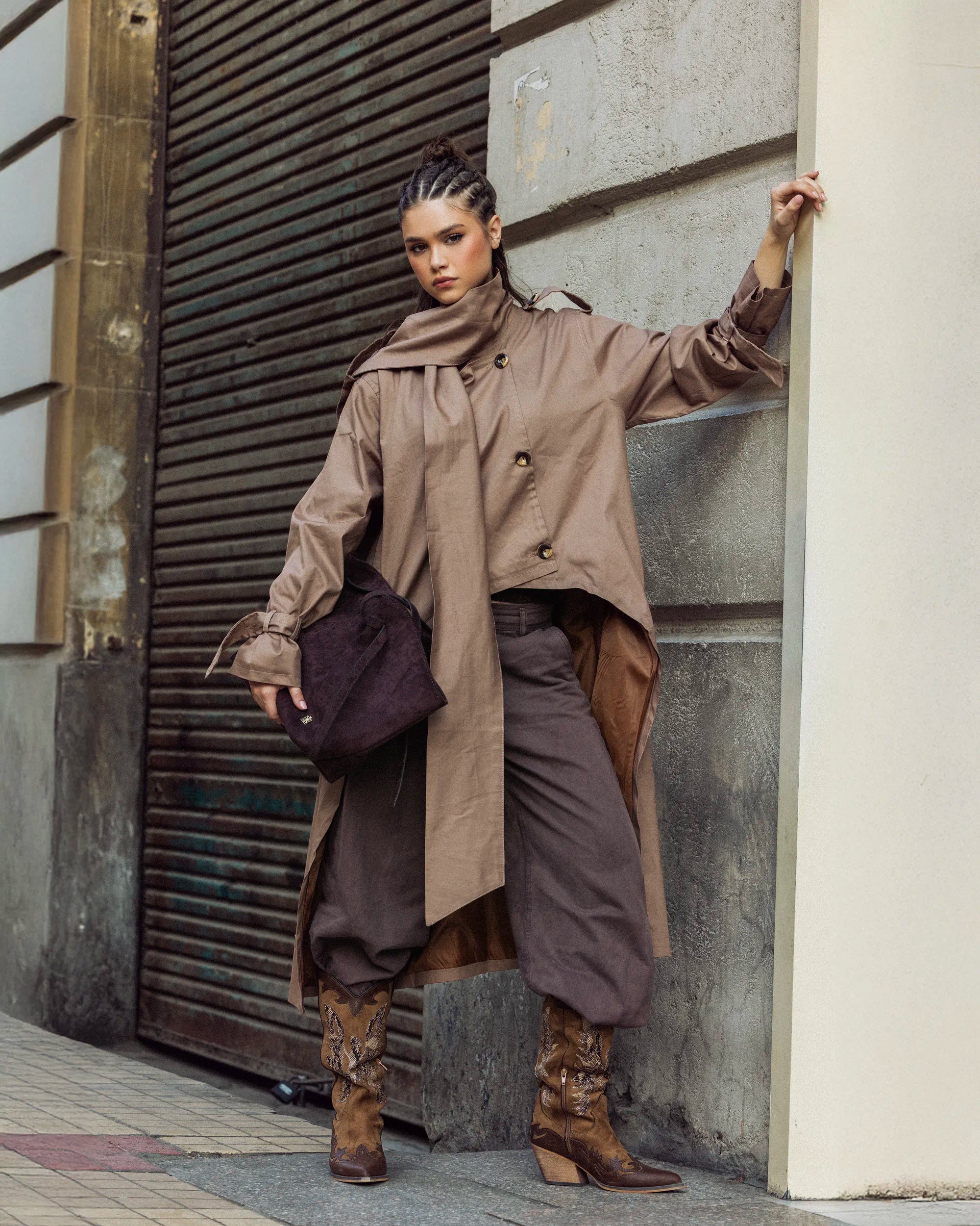 “Side-angle view of the beige A-Line Coat showing its clean tailoring and flared movement.”