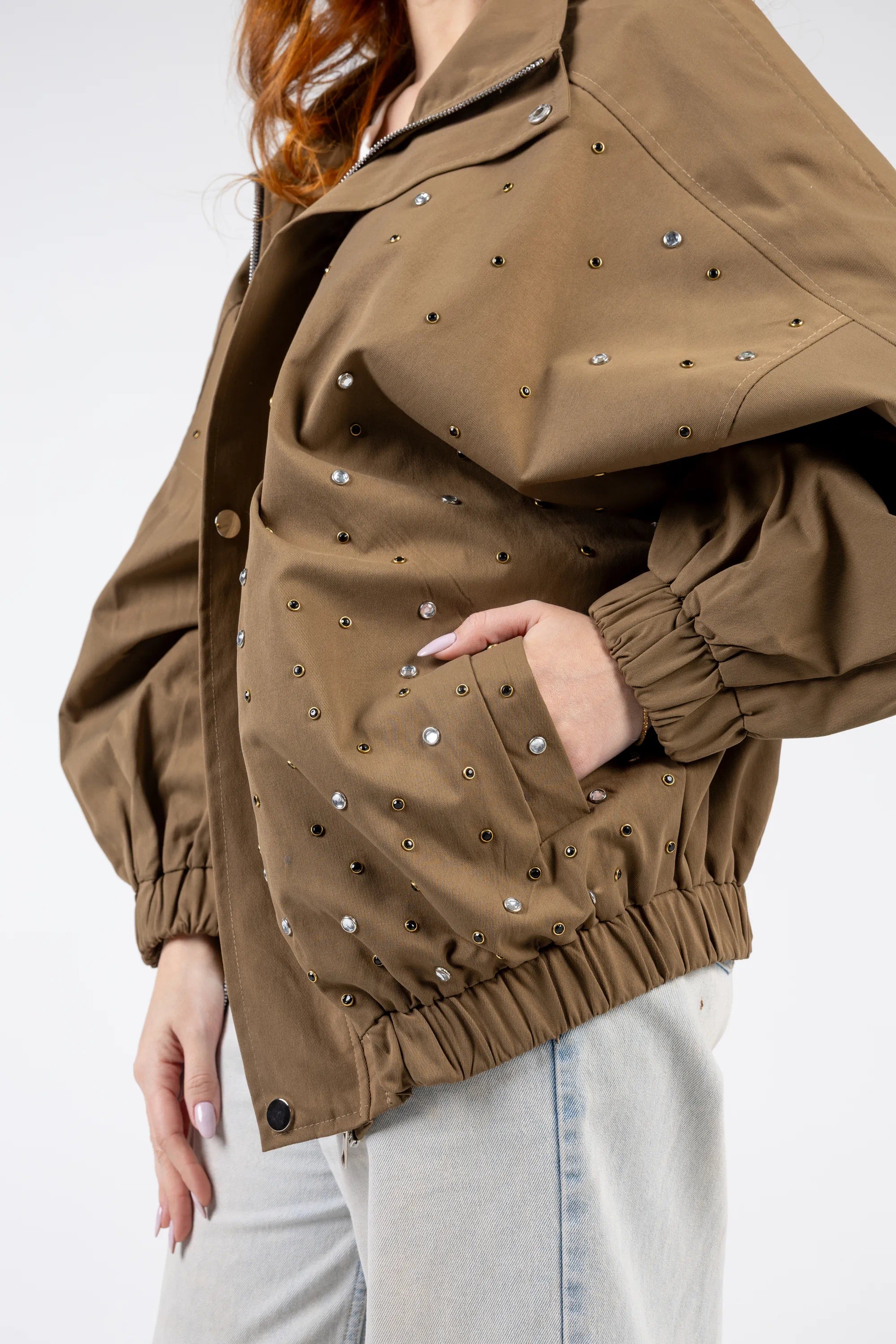 Brown jacket with pearl embellishments on a white background