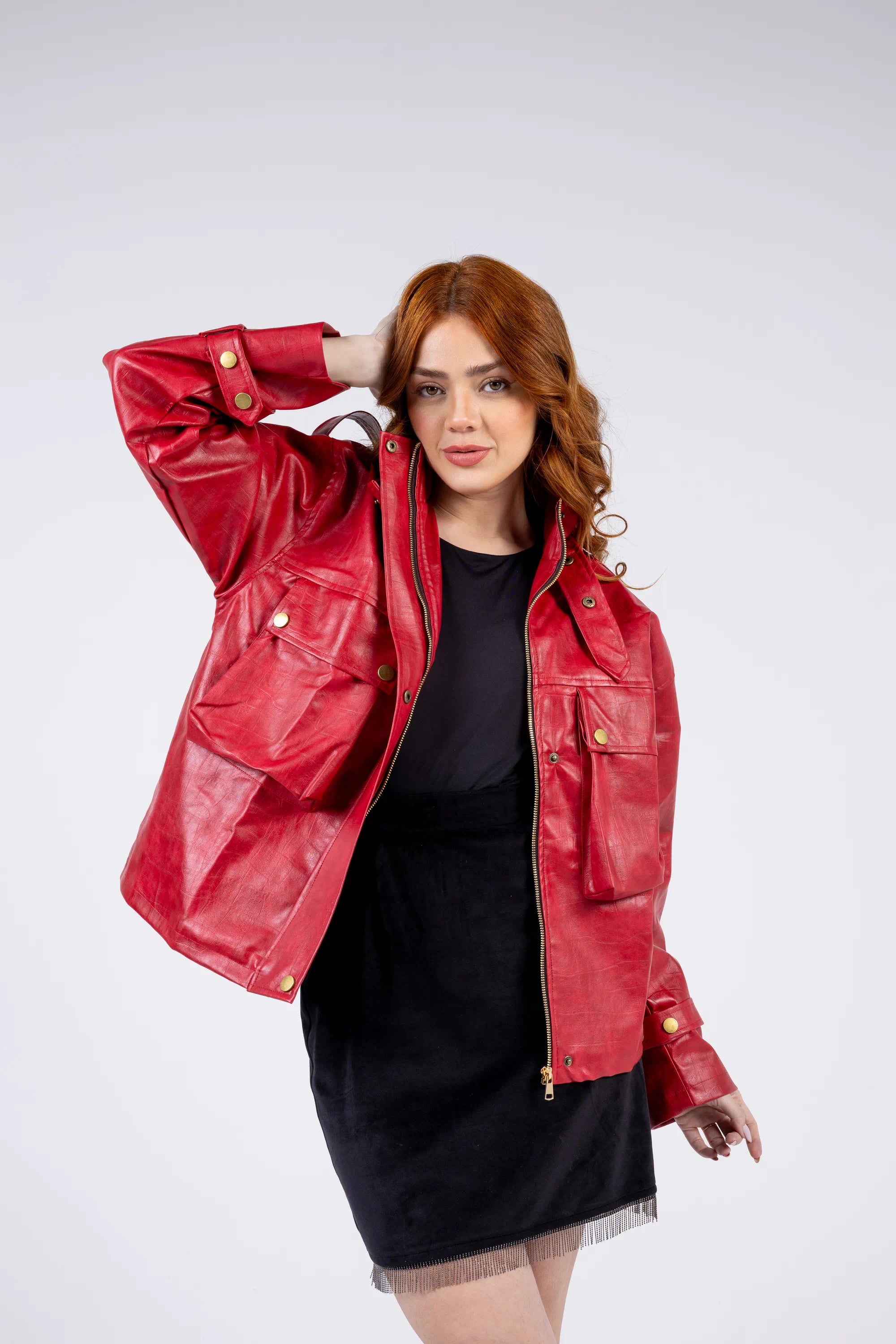 Woman wearing a red leather jacket on a white background