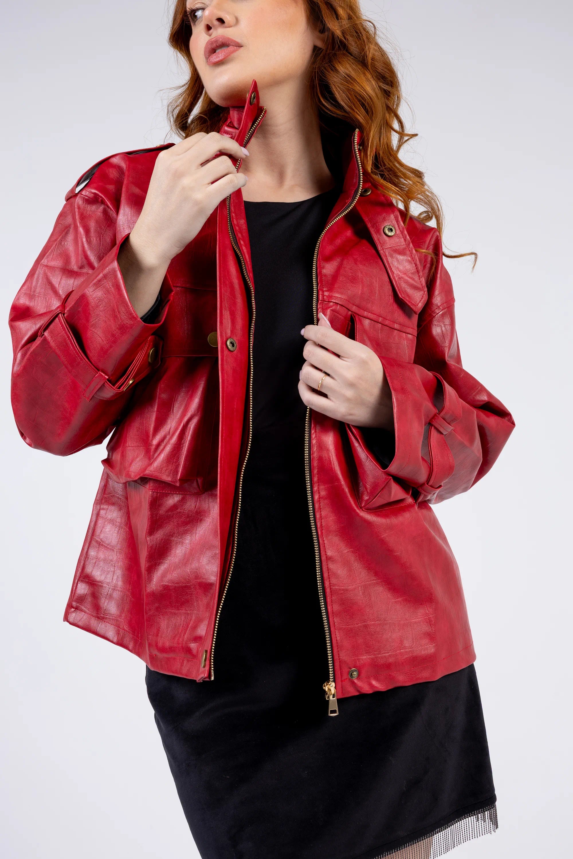 Woman wearing a red leather jacket on a white background