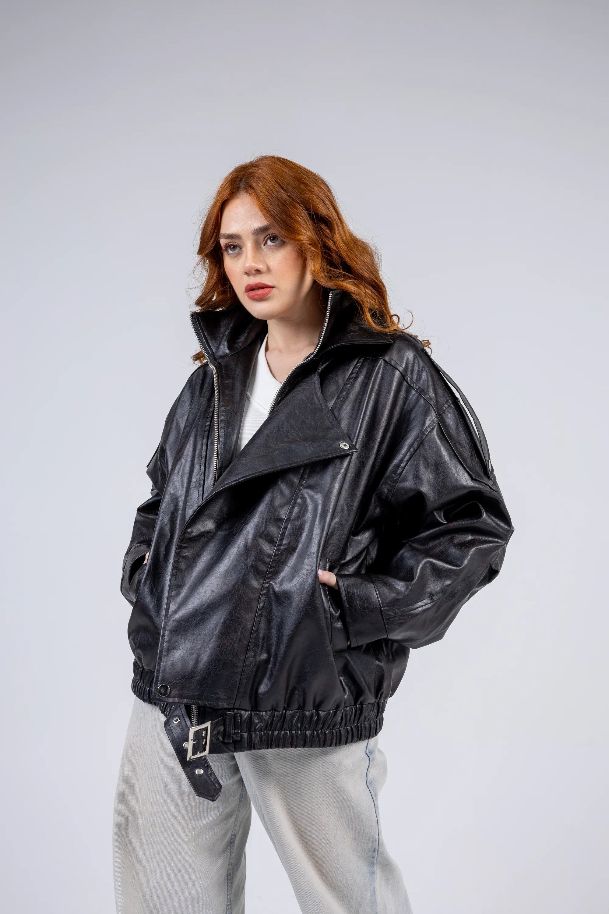 Woman wearing a black leather jacket on a white background