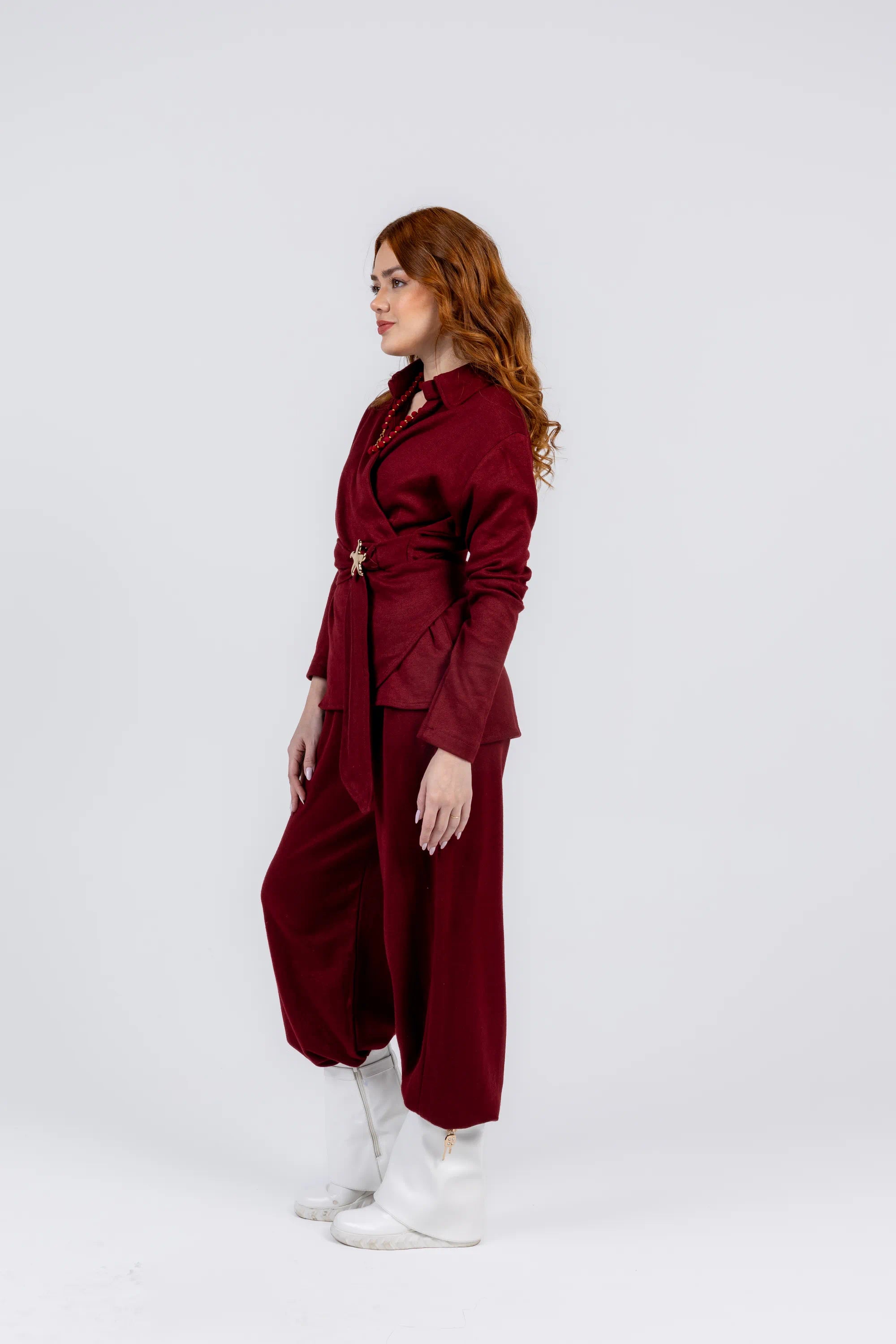 Woman wearing a burgundy outfit with a white background