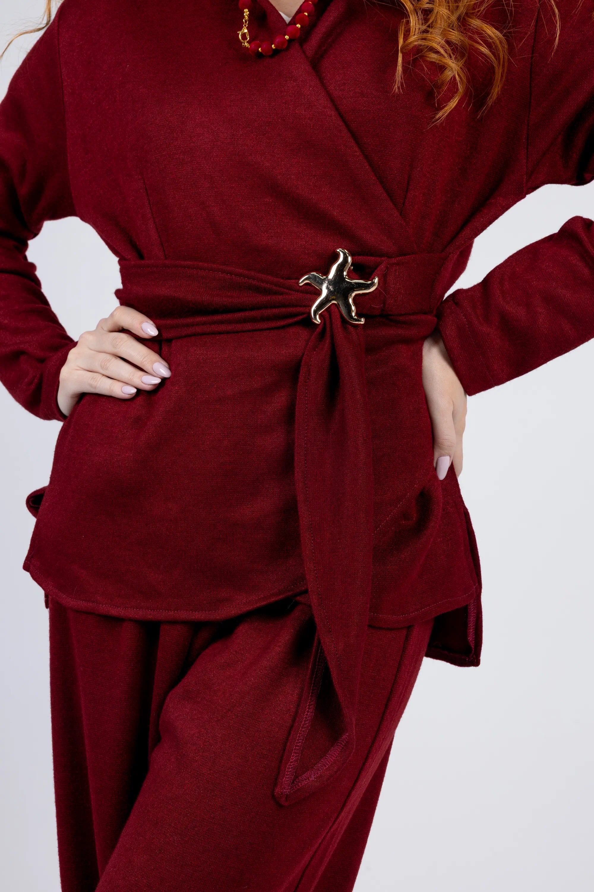 Red outfit with a belt featuring a decorative buckle on a white background