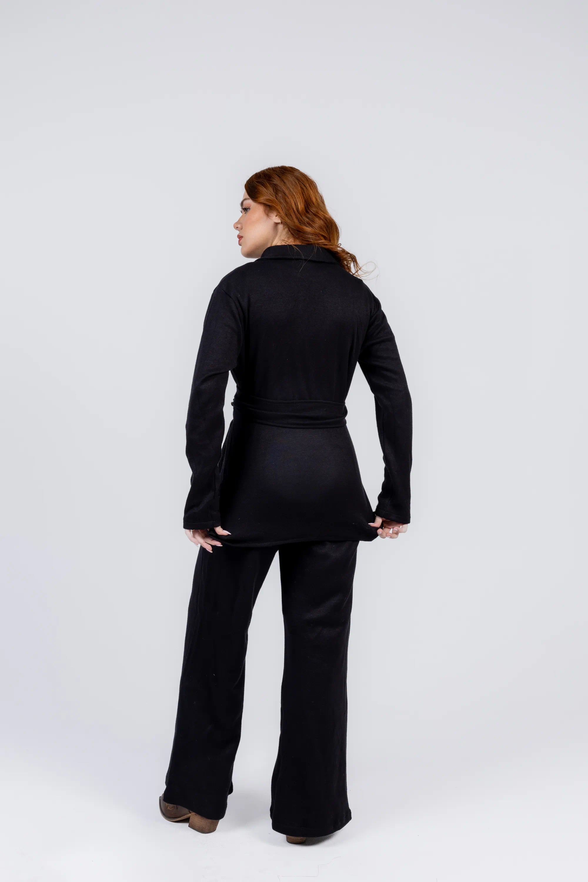 Woman wearing a black outfit on a white background