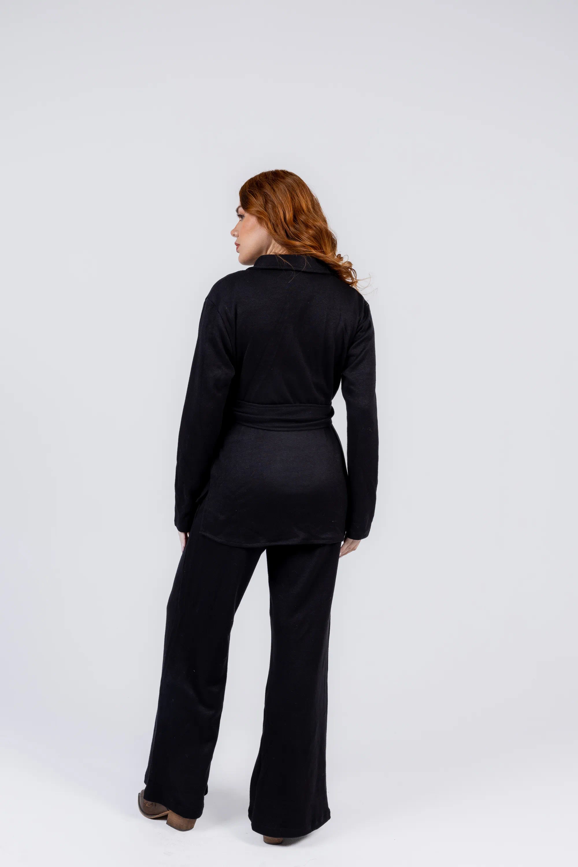 Woman wearing a black outfit on a white background