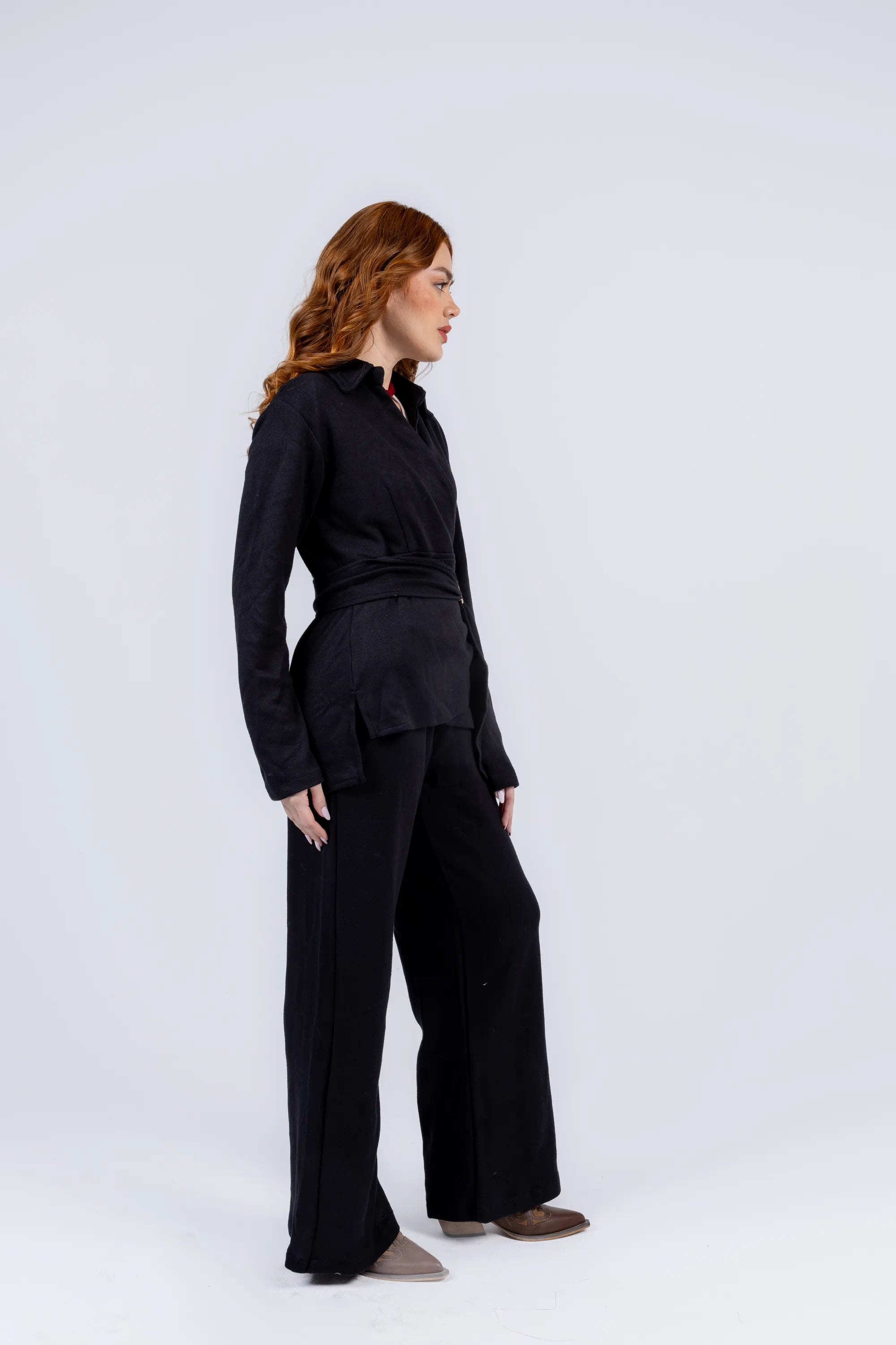 Person wearing a black outfit on a white background