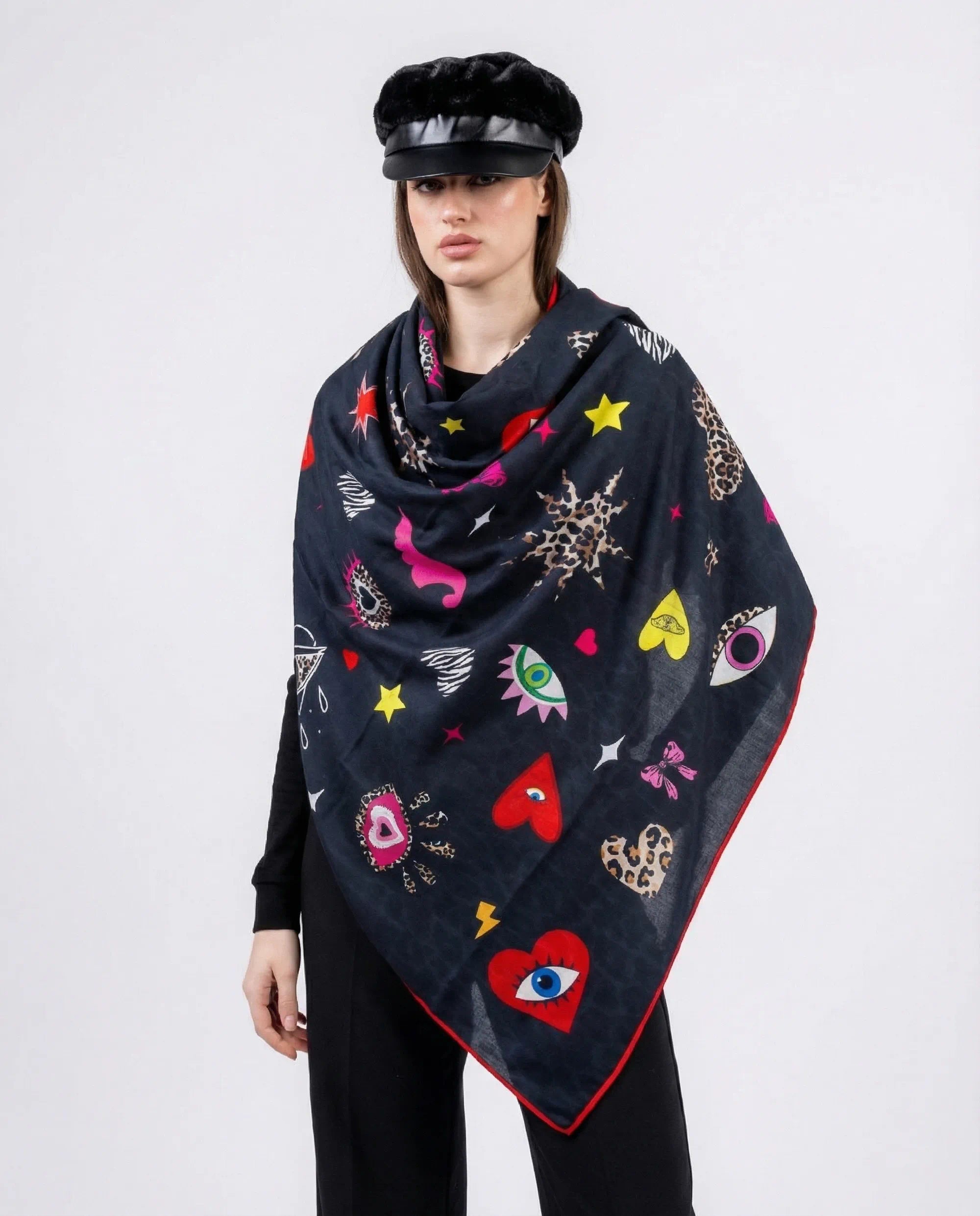 Woman wearing a dark blue scarf with colorful patterns on a white background